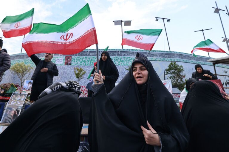 Iranian women and residents carry national flags during a demonstration protesting US military strikes on Iran, expressing support for their country amid rising tensions between Tehran and Washington. ASAL POST