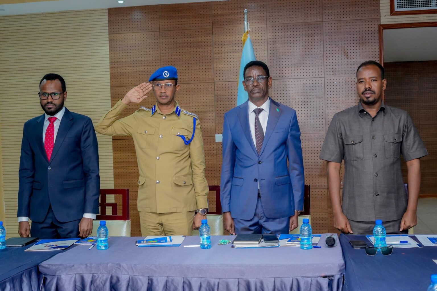 SOMALIA MOVES TO REDUCE ARMED ESCORTS FOR STATE OFFICIALS IN SECURITY REFORM PUSH. **Feature Image Caption:** Somalia’s Internal Security Minister Abdullahi Sheikh Ismail Fartaag stands in honour as security officers salute during the national anthem at a security conference in Mogadishu.